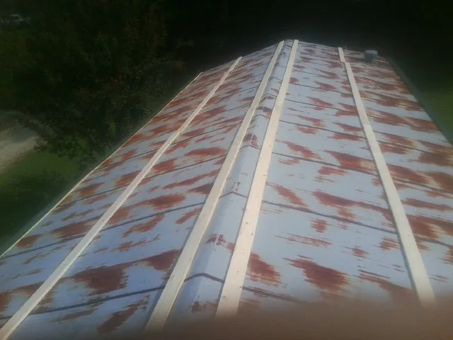 Rusted metal roof panels with new wood purlins before replacement — Storm Damage Roof Repair in Fort Knox by Roofing Brothers